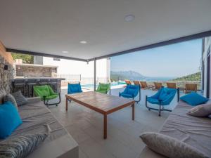 a living room with a table and chairs and a pool at Seaview Villa with pool-Vanja in Budva