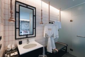 a bathroom with a sink and a mirror at SOOKNIRUND HOTEL in Chiang Rai