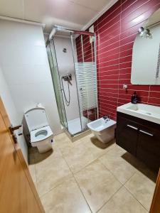 a bathroom with a toilet and a shower and a sink at Las Jarcias in Moncófar