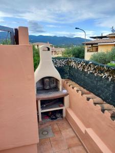 a pizza oven sitting on the side of a wall at I Coralli in Villasimius
