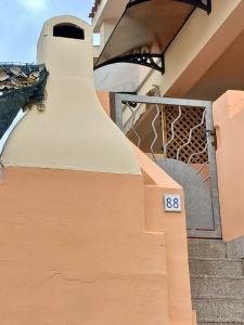 a stairway with a sign on the side of a building at I Coralli in Villasimius +36 photos