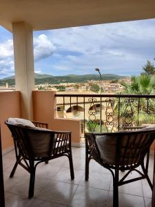 a balcony with a table and chairs and a view at I Coralli in Villasimius