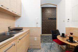 a kitchen with a sink and a table with chairs at Matejki-Lazurowy in Poznań