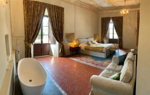 a living room with a bed and a couch at Castello del Poderetto in Licciana Nardi