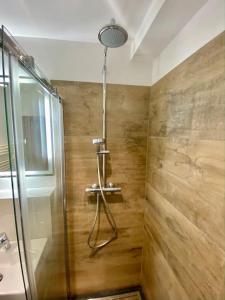 a bathroom with a shower with a glass door at Grubhof Studio mit Indoor Pool und Garten in Sankt Martin bei Lofer