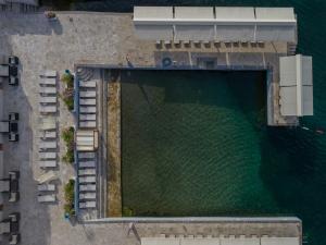 an overhead view of a swimming pool next to the water at Apartments Adeona in Tivat