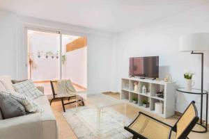 een woonkamer met een bank en een tv bij Luna de Málaga in Málaga