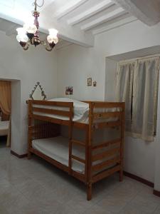 a bunk bed in a room with a chandelier at Casa Santina in borgo medievale in Prata