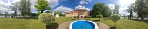 a large house with a blue pool in front of it at Schloss Zehdenick in Zehdenick