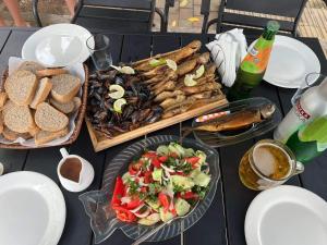 a table topped with plates of food and a salad at Apart townhouse in Kobuleti