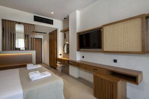 a hotel room with a television and a table at Balos Beach in Kissamos