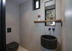 a bathroom with a toilet and a sink and a mirror at Balos Beach in Kissamos