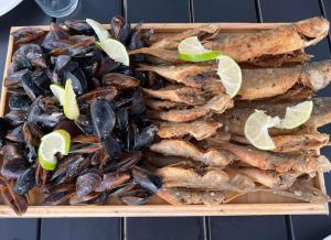 a tray of mussels and limes on a table at Apart townhouse in Kobuleti