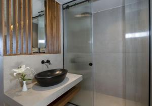 a bathroom with a sink and a glass shower at Balos Beach in Kissamos