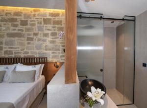 a bedroom with a bed and a glass shower at Balos Beach in Kissamos