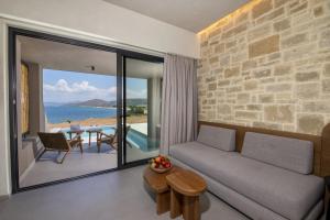 a living room with a couch and a view of the ocean at Balos Beach in Kissamos
