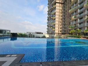 a large swimming pool in front of a building at Mây Homestay in Hanoi