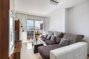 a living room with a couch and a tv at Apartamento Clayma in Puerto de Mazarrón