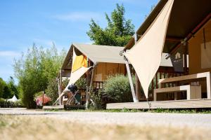 a building with a tent in front of it at Glamping Ornans in Ornans