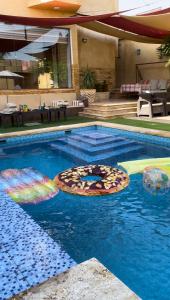 a swimming pool with two pizzas in the water at Orient Villa-Dead Sea in Sowayma