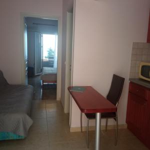 a room with a table and a couch and a bed at Niki Sunrise Apartments in Gastourion