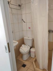 a small bathroom with a toilet and a sink at Niki Sunrise Apartments in Gastouri