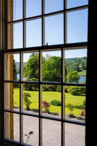 uma janela com vista para um jardim visto através dele em Knipoch House Hotel em Oban