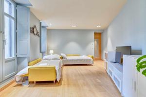um quarto com 2 camas e uma televisão em Apartamento El Rincón del Chupinazo em Pamplona