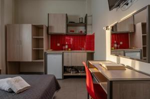 a kitchen with a desk and a table in a room at Sunshine Apartments in Neos Marmaras