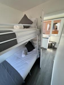 a couple of bunk beds in a room at Cozzzy Seaside Retreat in Mablethorpe