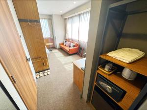 a room with a door and a living room at HOTEL SUI AKASAKA by ABEST in Tokyo