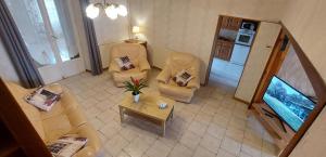 a living room with two couches and a table at Chez marcelle in Éteignières