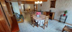 a dining room table with a vase of flowers on it at Chez marcelle in Éteignières +10 photos
