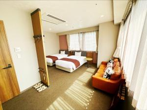 a hotel room with a bed and a couch at HOTEL SUI AKASAKA by ABEST in Tokyo