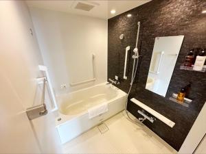 a bathroom with a sink and a bath tub at HOTEL SUI AKASAKA by ABEST in Tokyo