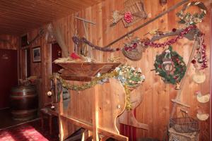 a room with a wooden wall with christmas decorations at Guest House Chalet Saint Roch in Albiez-Montrond +26 photos