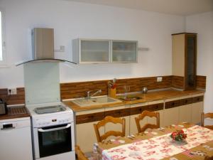 a kitchen with a table and a stove and a sink at Les rosieres 
