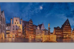 a painting of a city at night with buildings at City Apartment in berühmter Lage in Hildesheim