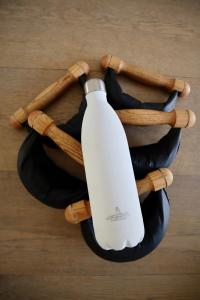 a bottle of wine on a wooden table at La Ferme D'Augustin in Saint-Tropez