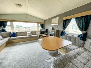 a living room with a table and a couch at Lovely 8 Berth Caravan At Manor Park Nearby Hunstanton Beach 23107s in Hunstanton