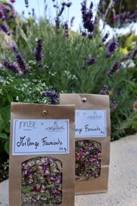two boxes of flowers in front of a garden at La Ferme D'Augustin in Saint-Tropez