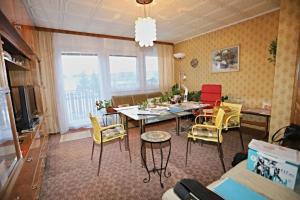 a living room with a dining room table and chairs at Rodinný dům pro hosty Vysočiny 