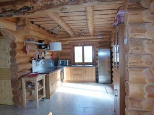 eine Küche in einem Blockhaus mit einer Theke in der Unterkunft La fuste ardennaise in Haybes