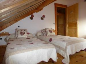 a bedroom with two beds with white sheets at La fuste ardennaise in Haybes