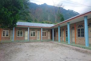 a large brick building with a lot of windows at Penginapan Rindu Alam Soala Gogo in Tongging