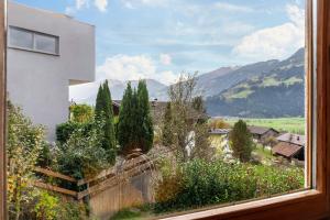 a window with a view of a mountain at Apart Spieljoch 90m2 in Bruck am Ziller