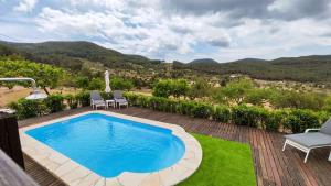 a pool on a patio with a view of the mountains at Can Pep de San Plana in Sant Josep de Sa Talaia