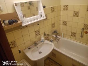 a bathroom with a sink and a tub and a mirror at Rodinný dům pro hosty Vysočiny 