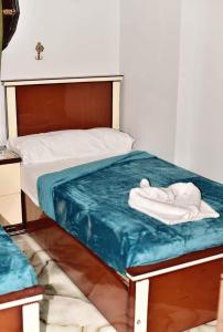a bed with two towels on top of it at Elwazan Hotel in Quseir