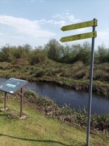 a street sign in the grass next to a river at Apart townhouse in K'obulet'i